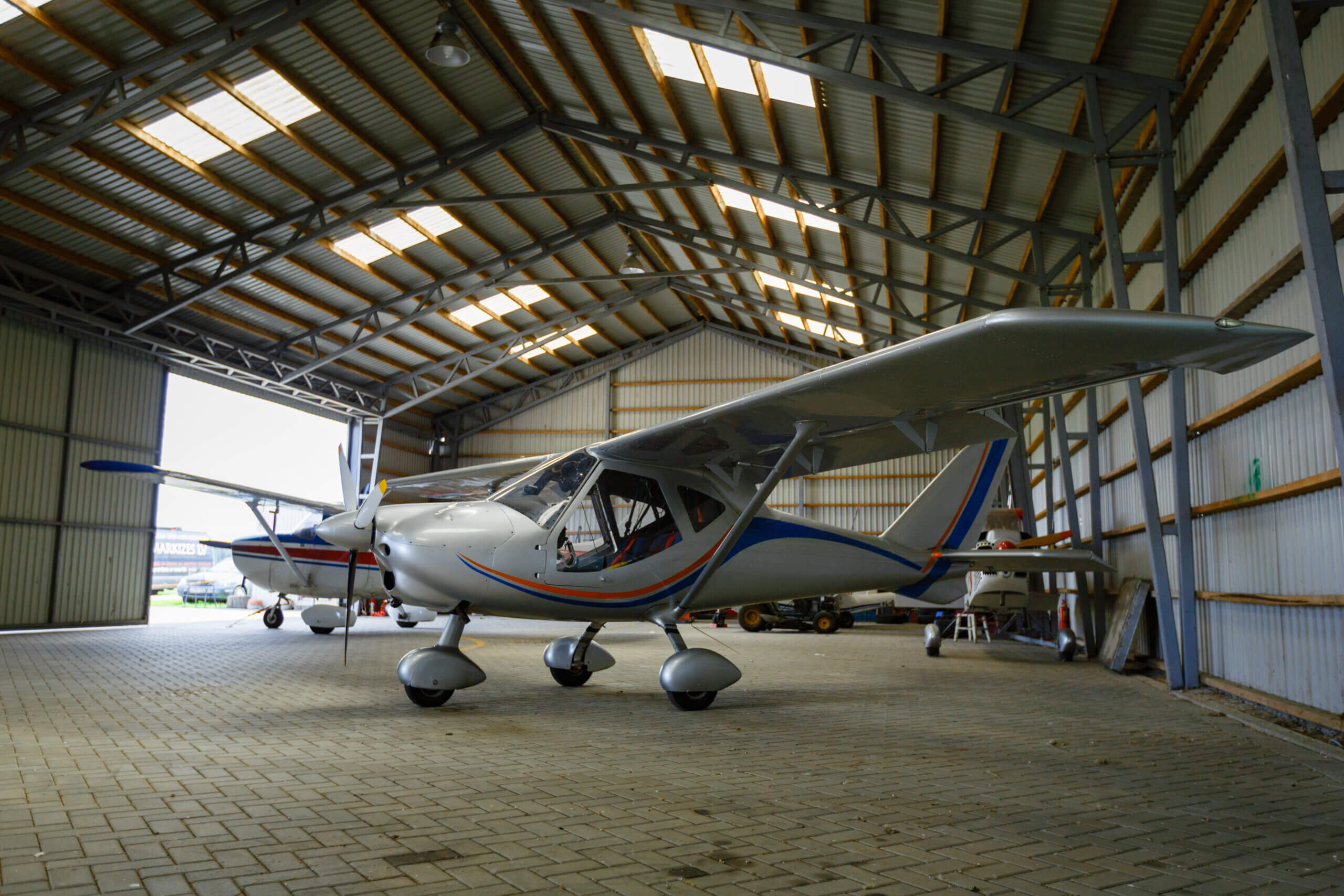 An-interior-shot-of-small-plane-standing-in-aviation-metal-hangar